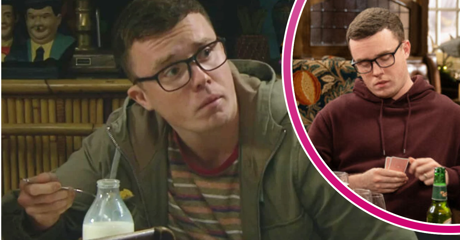 Vinny looking worried and looking at a deck of cards in Emmerdale