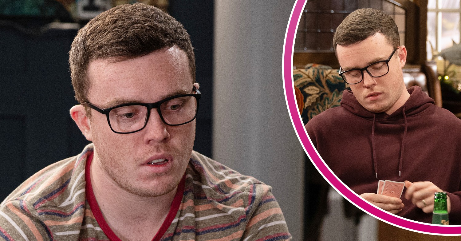 Vinny looking worried and looking at a deck of cards in Emmerdale