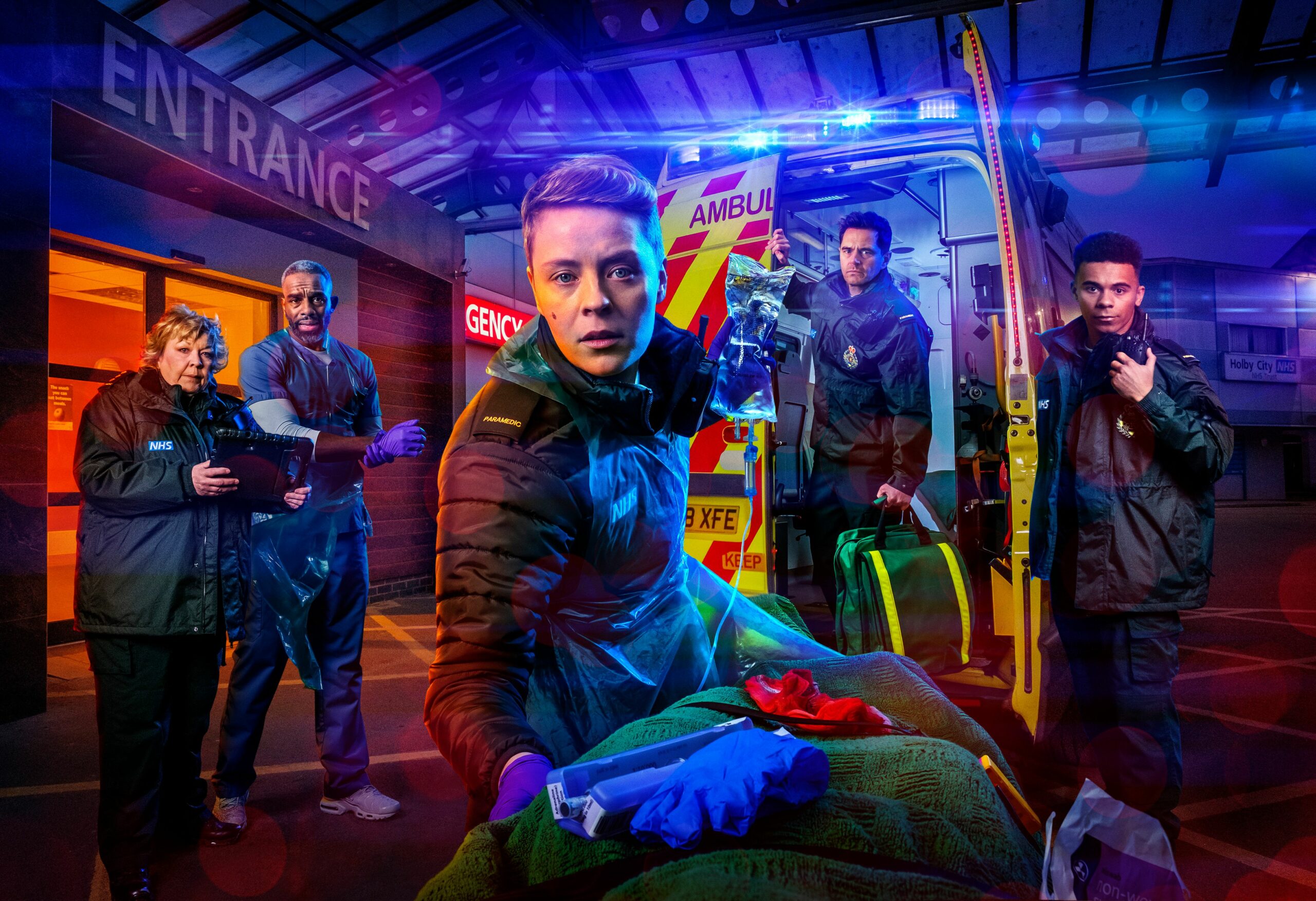 Casualty cast looking concerned in an ambulance