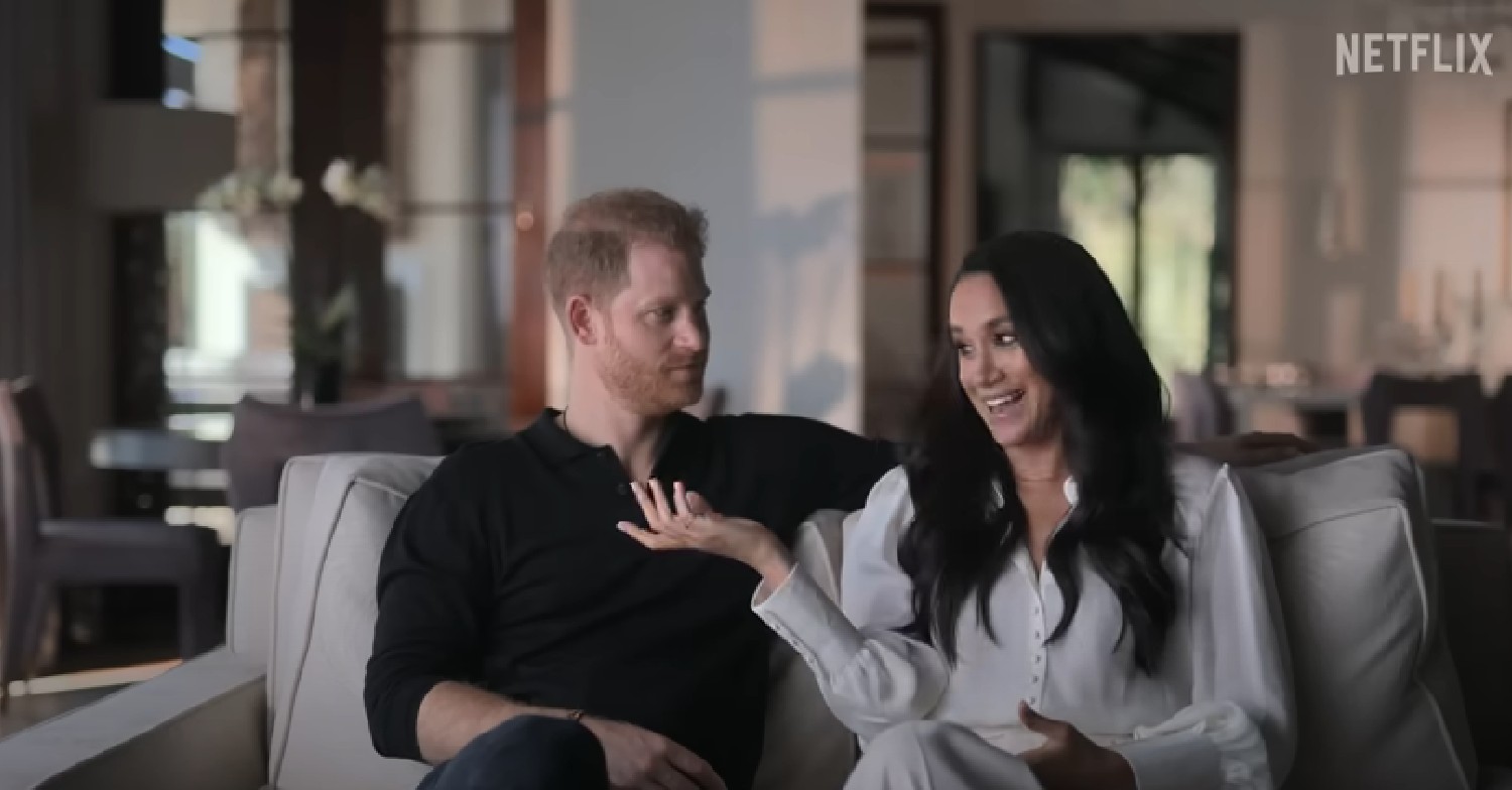 Harry looking at Meghan as she's talking in Netflix show