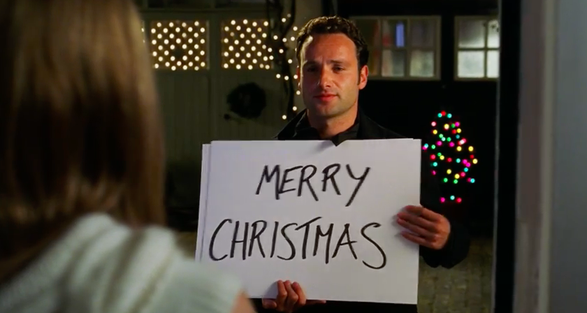 Love Actually star Andrew Lincoln holding up a Merry Christmas sign