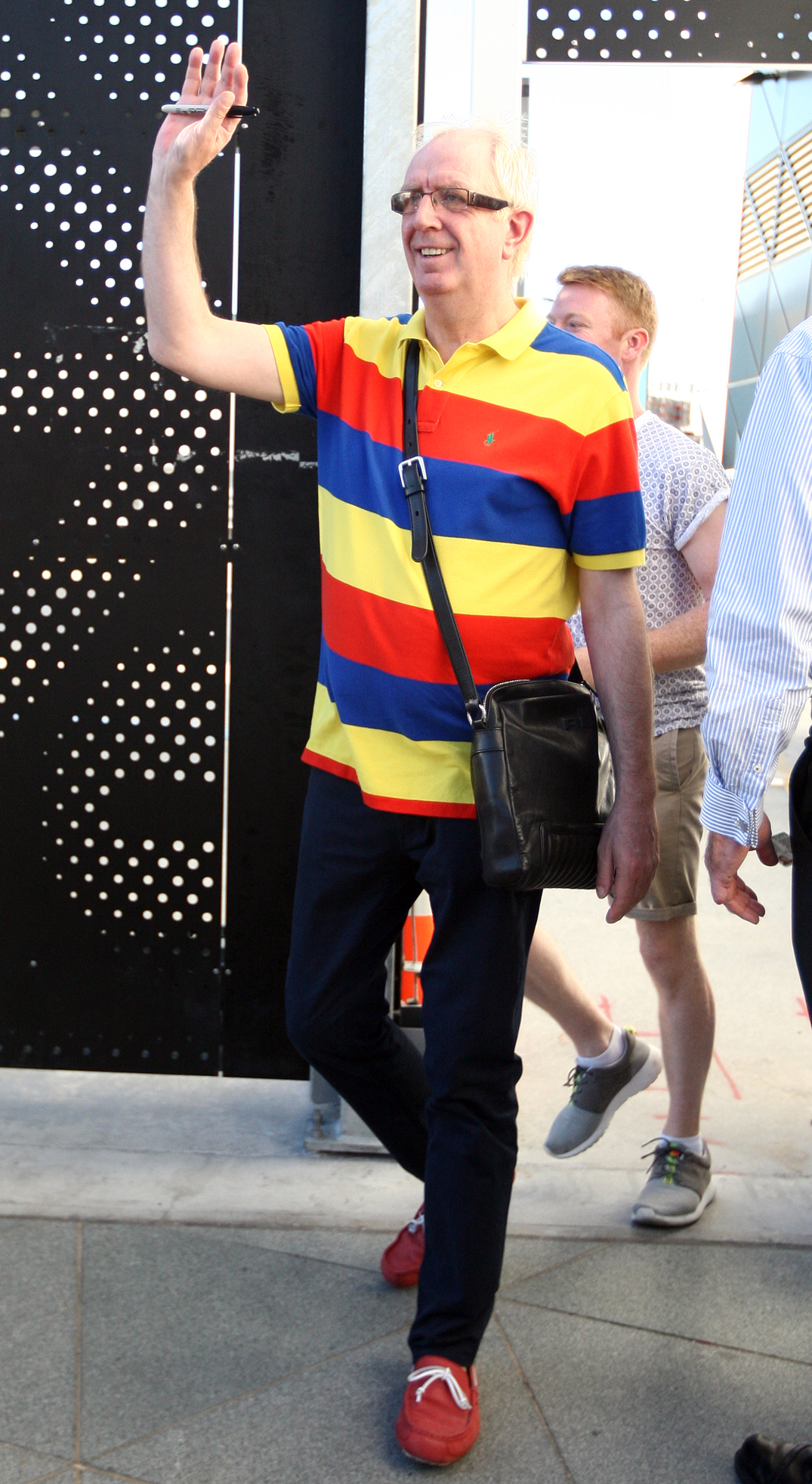 Mrs Brown's Boys star Rory waving in a bright striped top