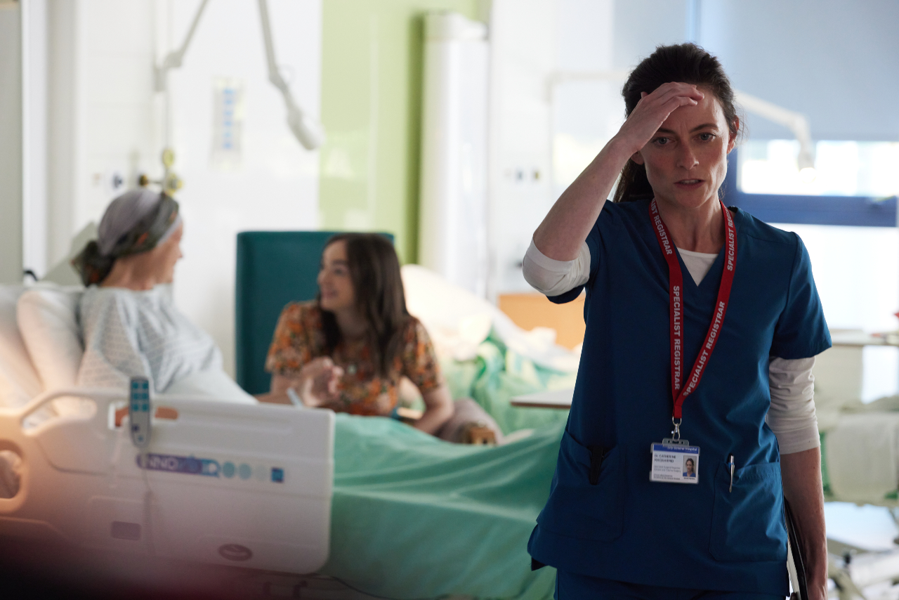 Catherine holds her head in the hospital in Maternal