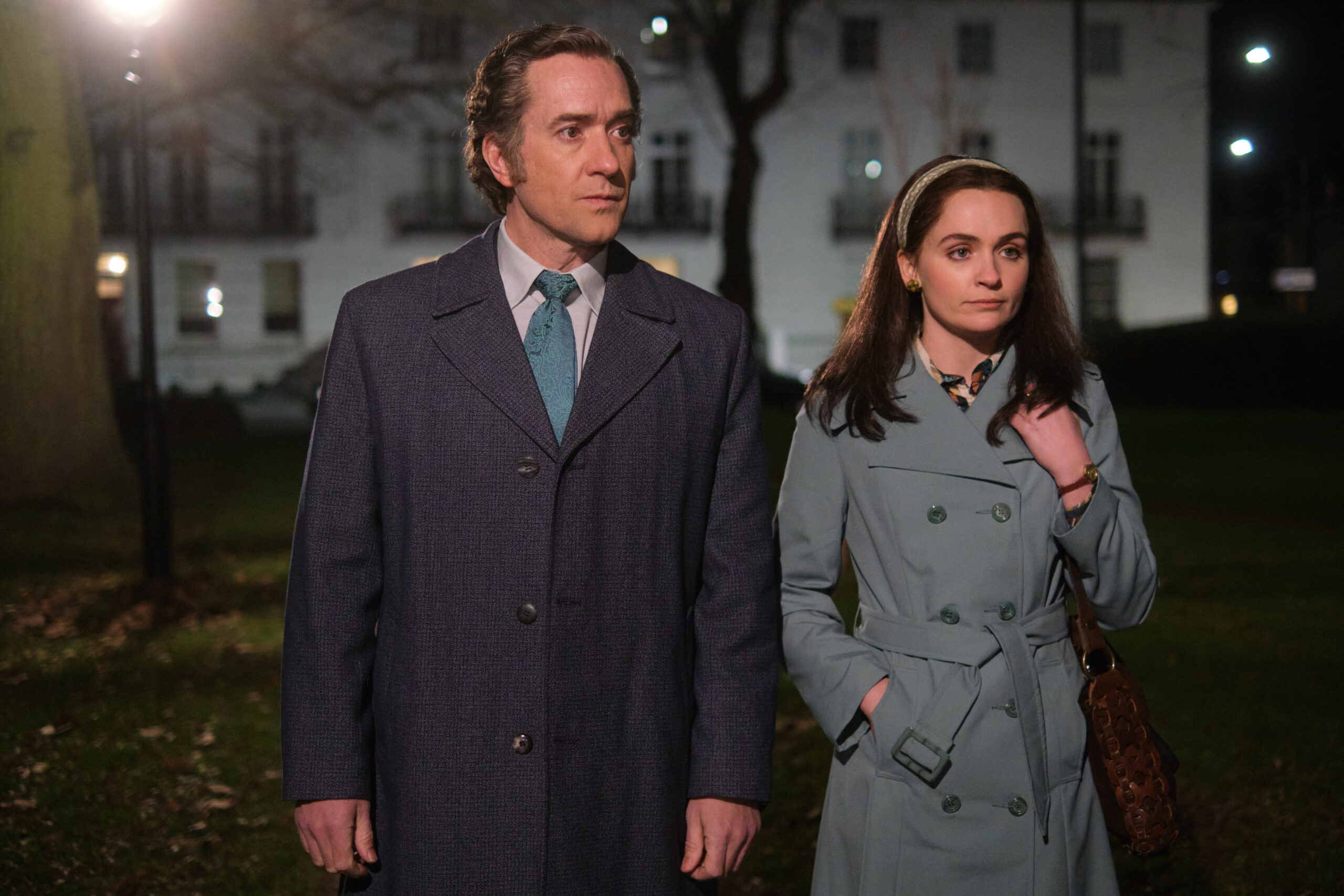 John Stonehouse and Sheila Buckley walk through the street together