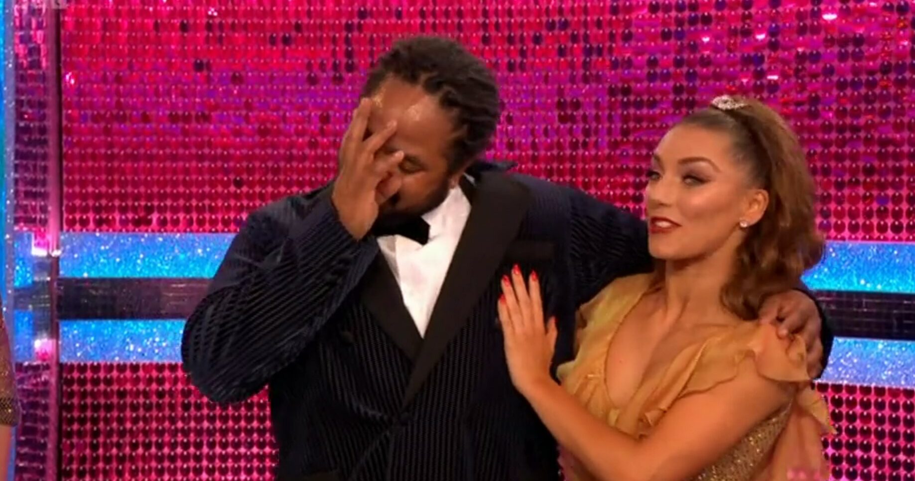 Hamza Yassin covers his face and cries as Jowtia comforts him during the Strictly Final