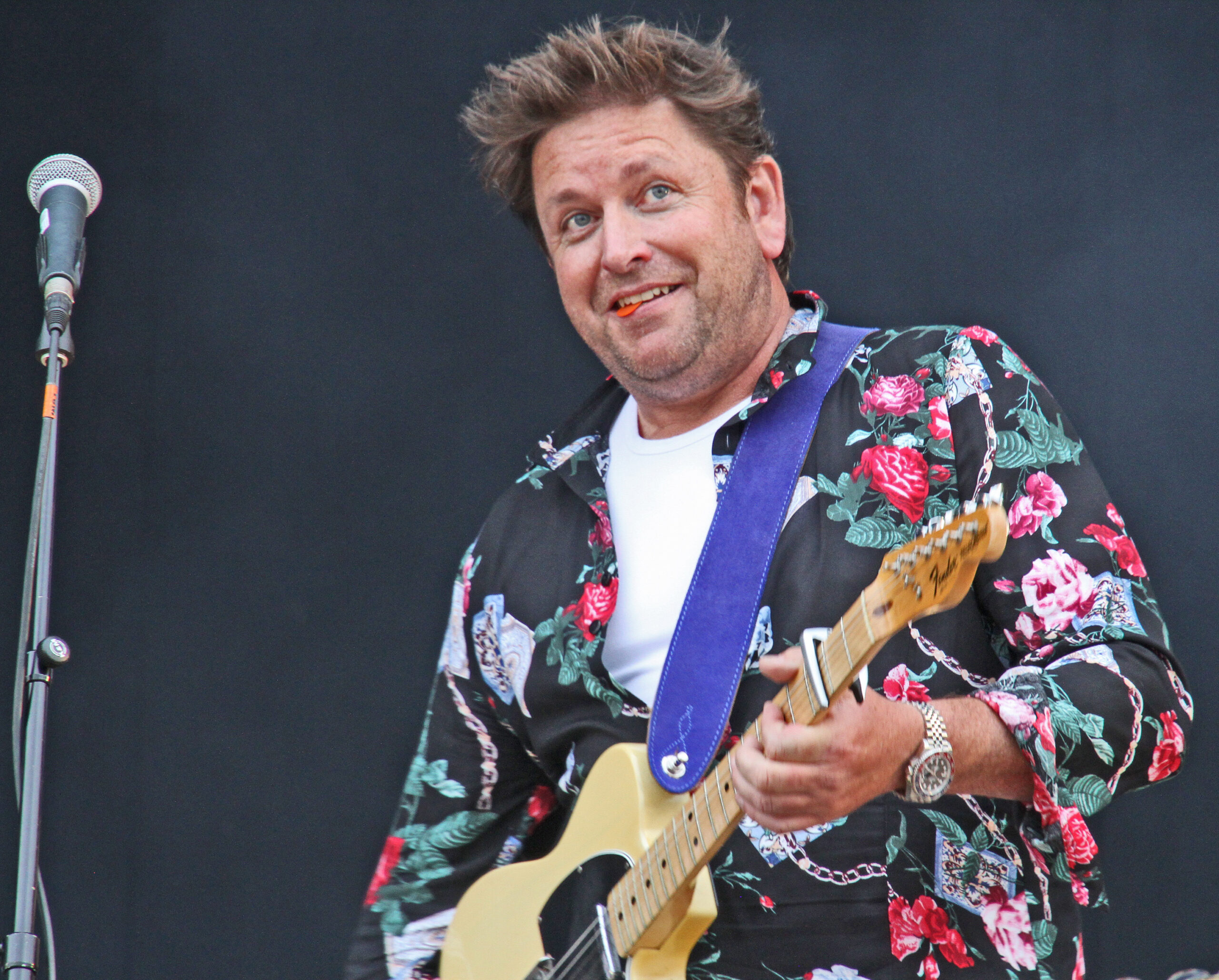 James Martin playing the guitar on tour