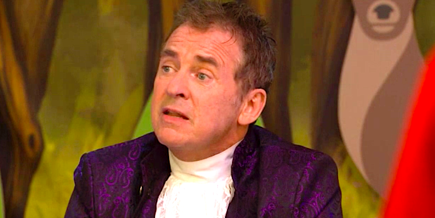 Alfie in panto outfit looking thoughtful