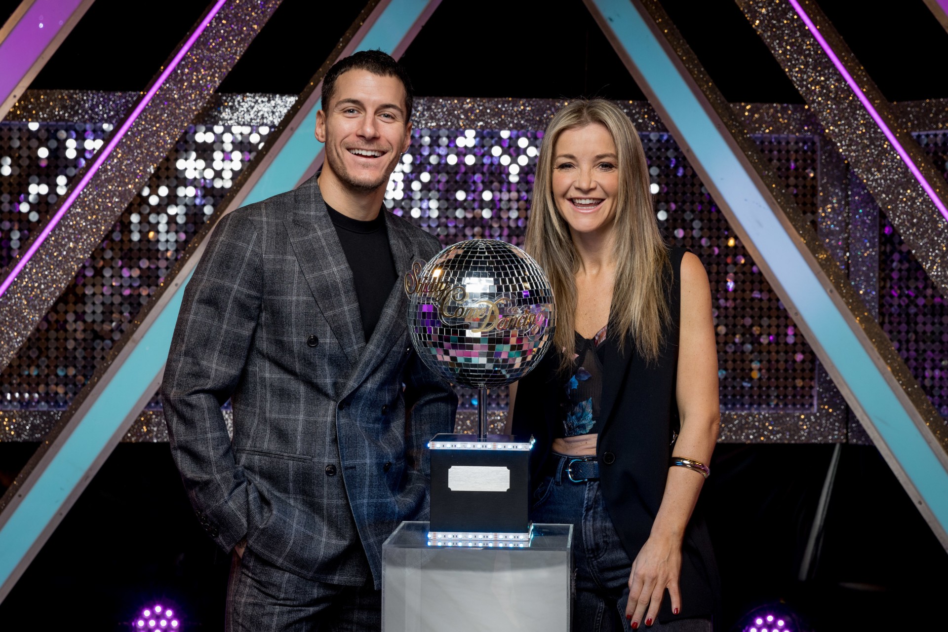 Helen Skelton and Gorka Marquez standing with the glitterball trophy