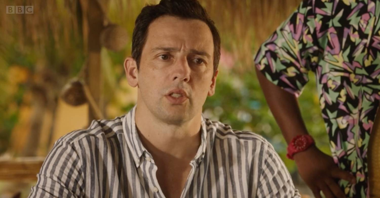 Death In Paradise star Ralf Little in character