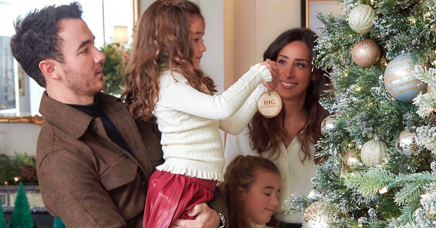 A family decorating a Christmas tree