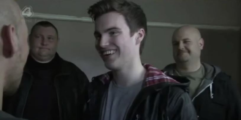 Andrew Still as Joel Dexter smiling smugly on Hollyoaks
