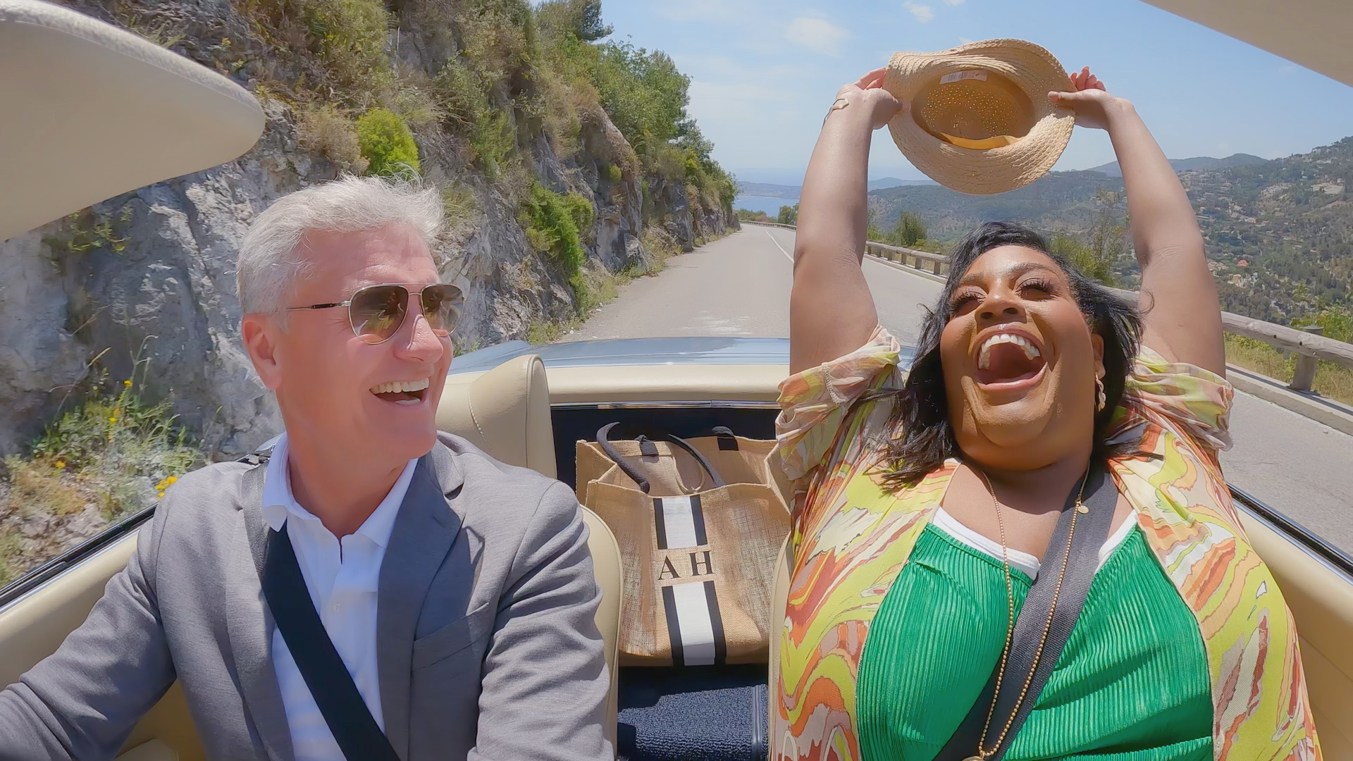 David Coulthard laughs as Alison Hammond throws her hat above her head in sports car
