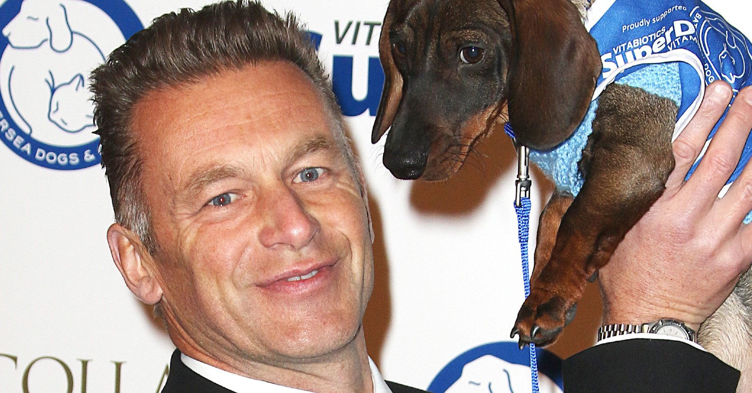 Chris Packham holding a dog