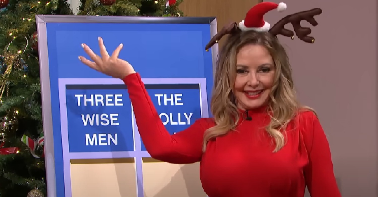 Carol Vorderman holding her arm up in red dress on This Morning