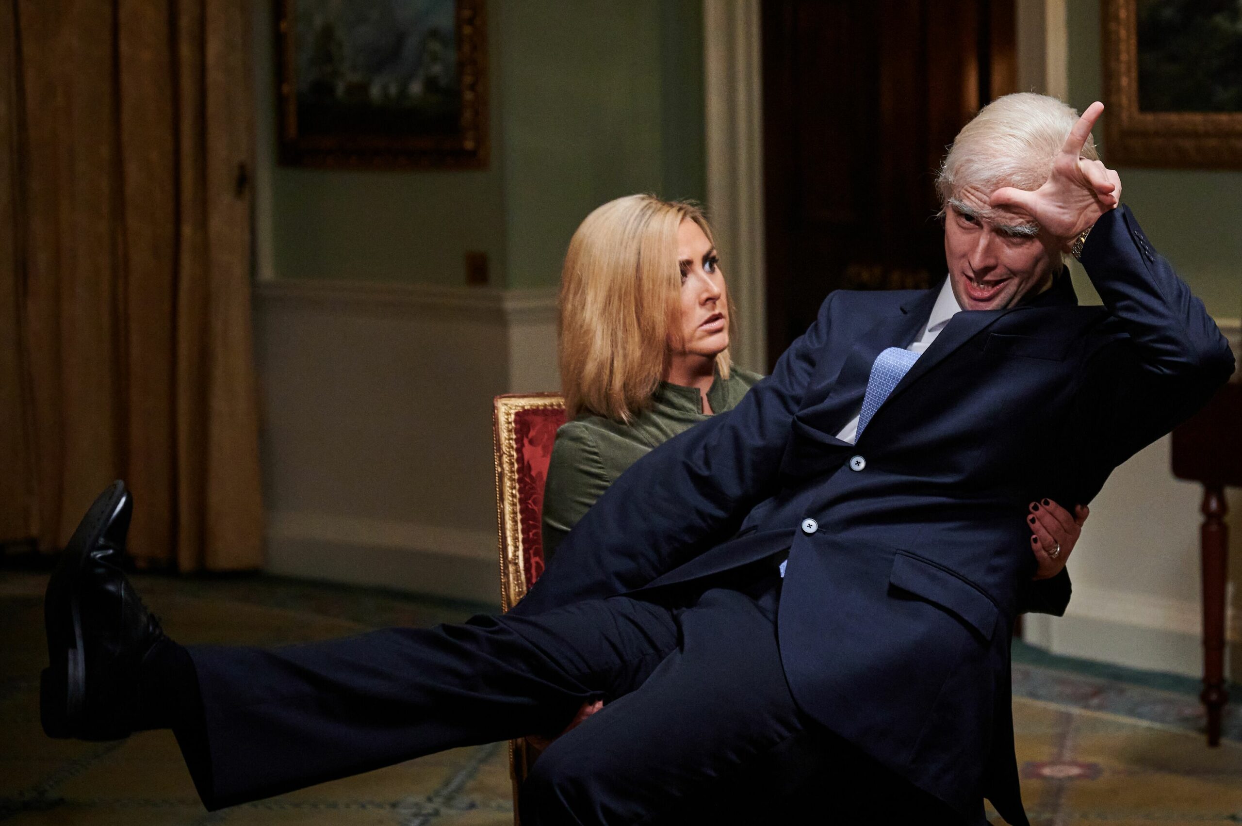 Prince Andrew sits on Emily Maitis' knee in the musical