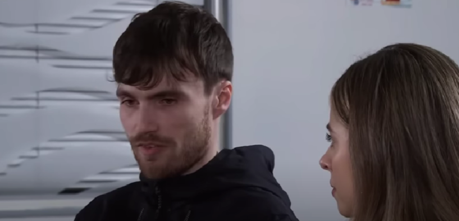 A man looking upset as he talks to Daisy in Corrie