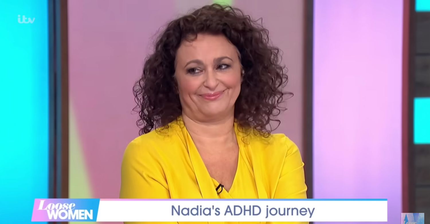 Nadia Sawalha smiles wearing a yellow dress on Loose Women