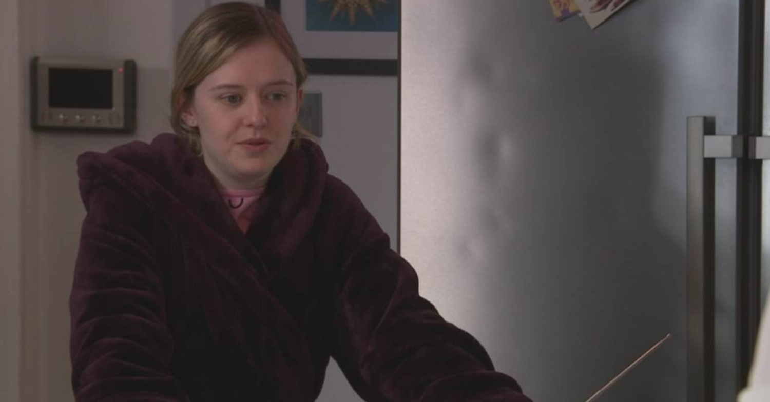 Coronation Street's Summer is in her dressing gown, standing next to a dented fridge