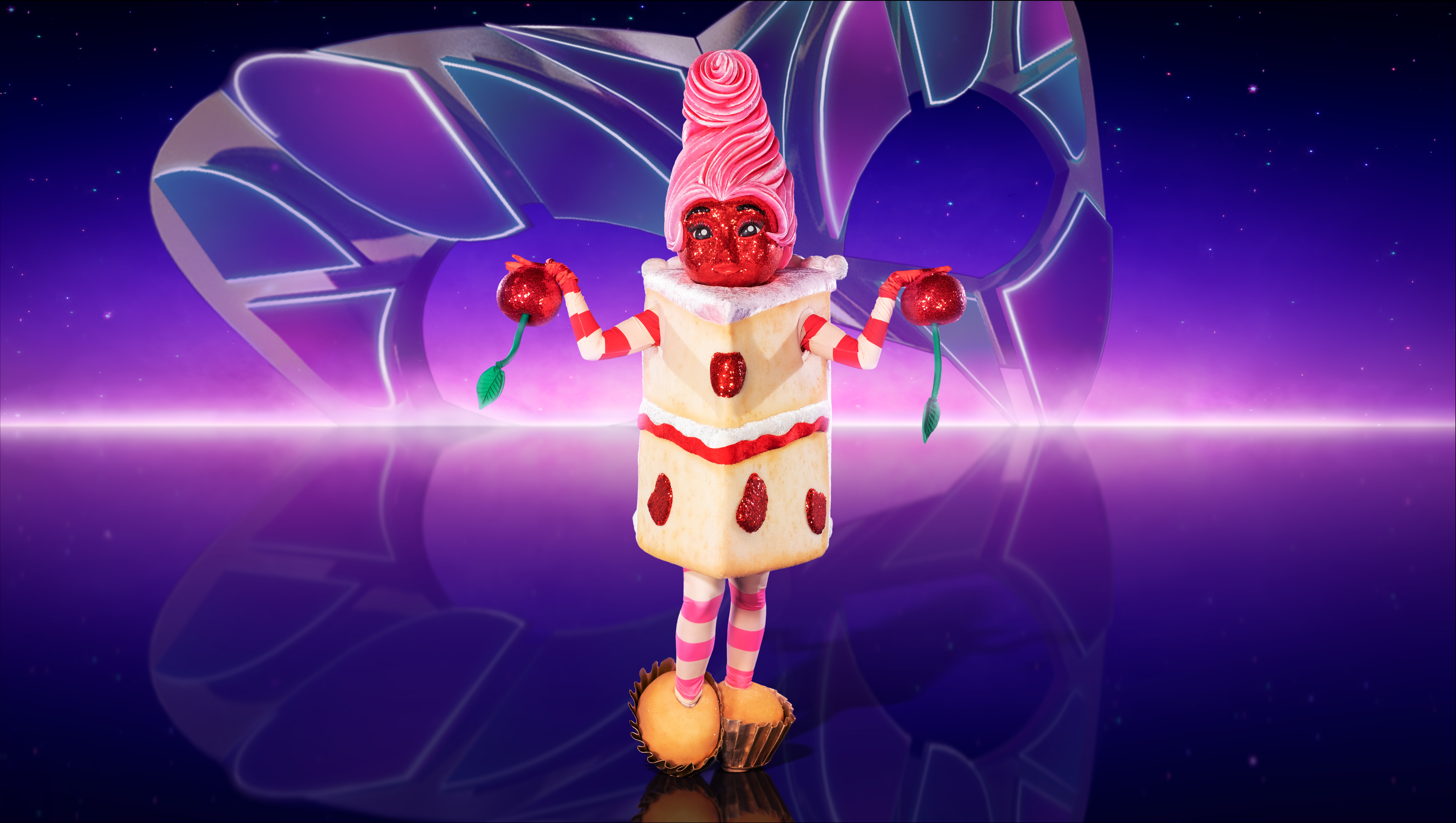 Piece of Cake holds arms up in The Masked Singer 2023