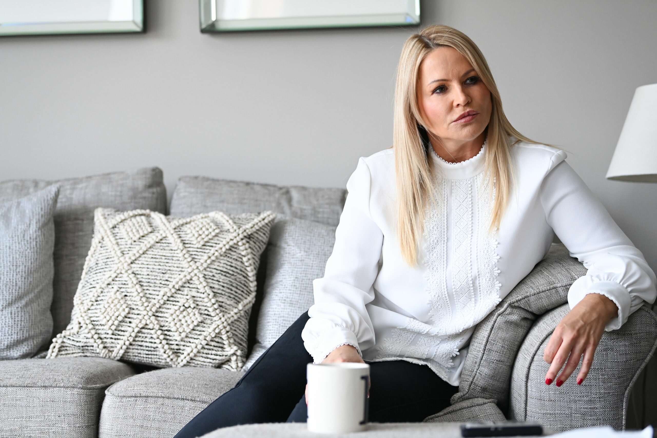 Louise Speed sits in her house