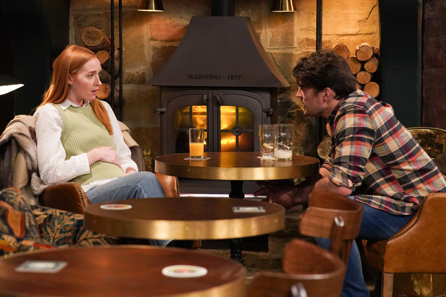 Chloe in Emmerdale places her hand on her bump looking horrified at Mackenzie