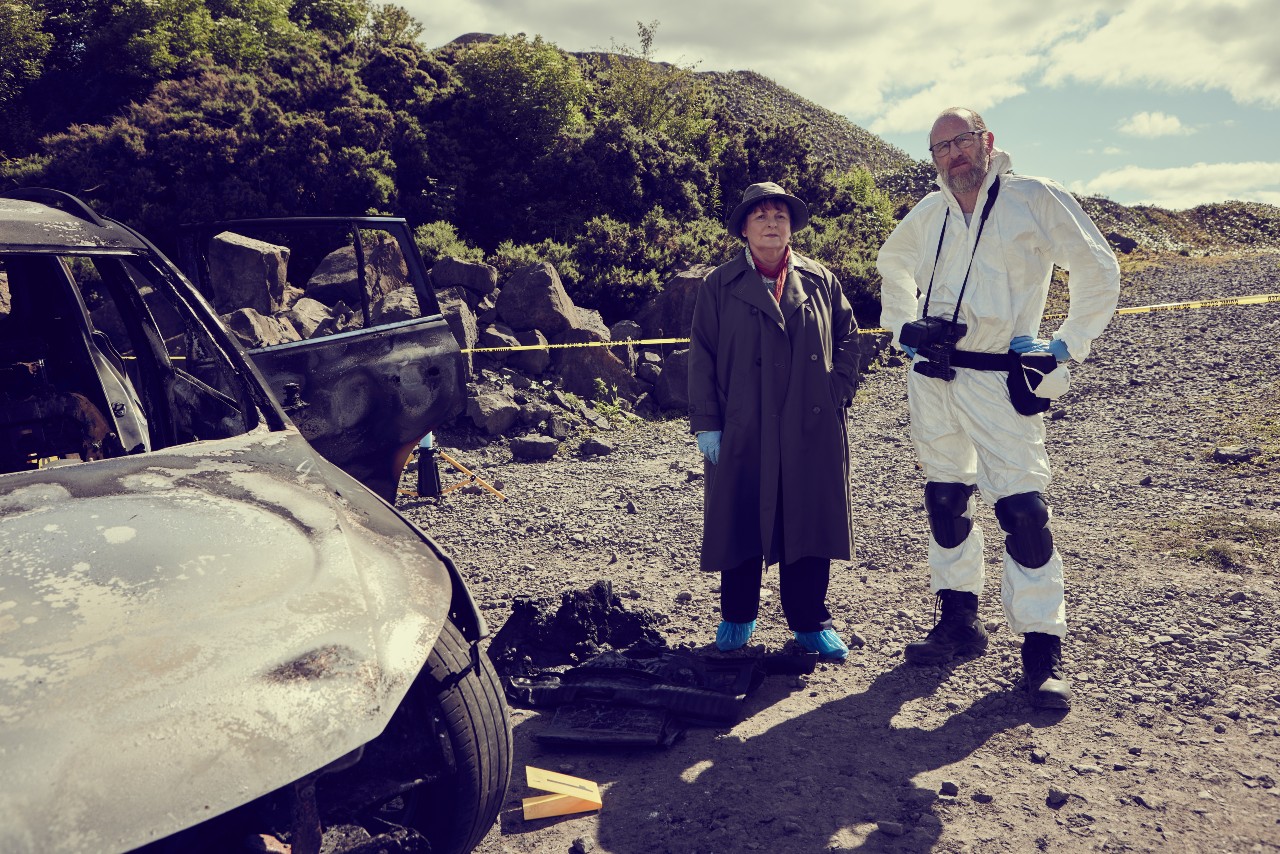 Vera and Dr Malcolm Donahue stand on the beach