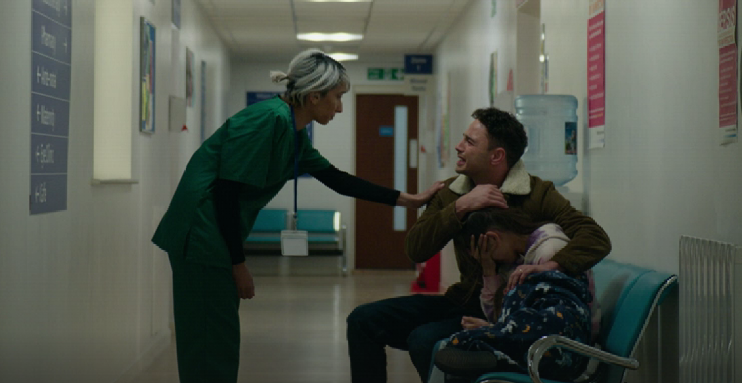 Donte crying as he looks at the nurse and holds his children in Waterloo Road