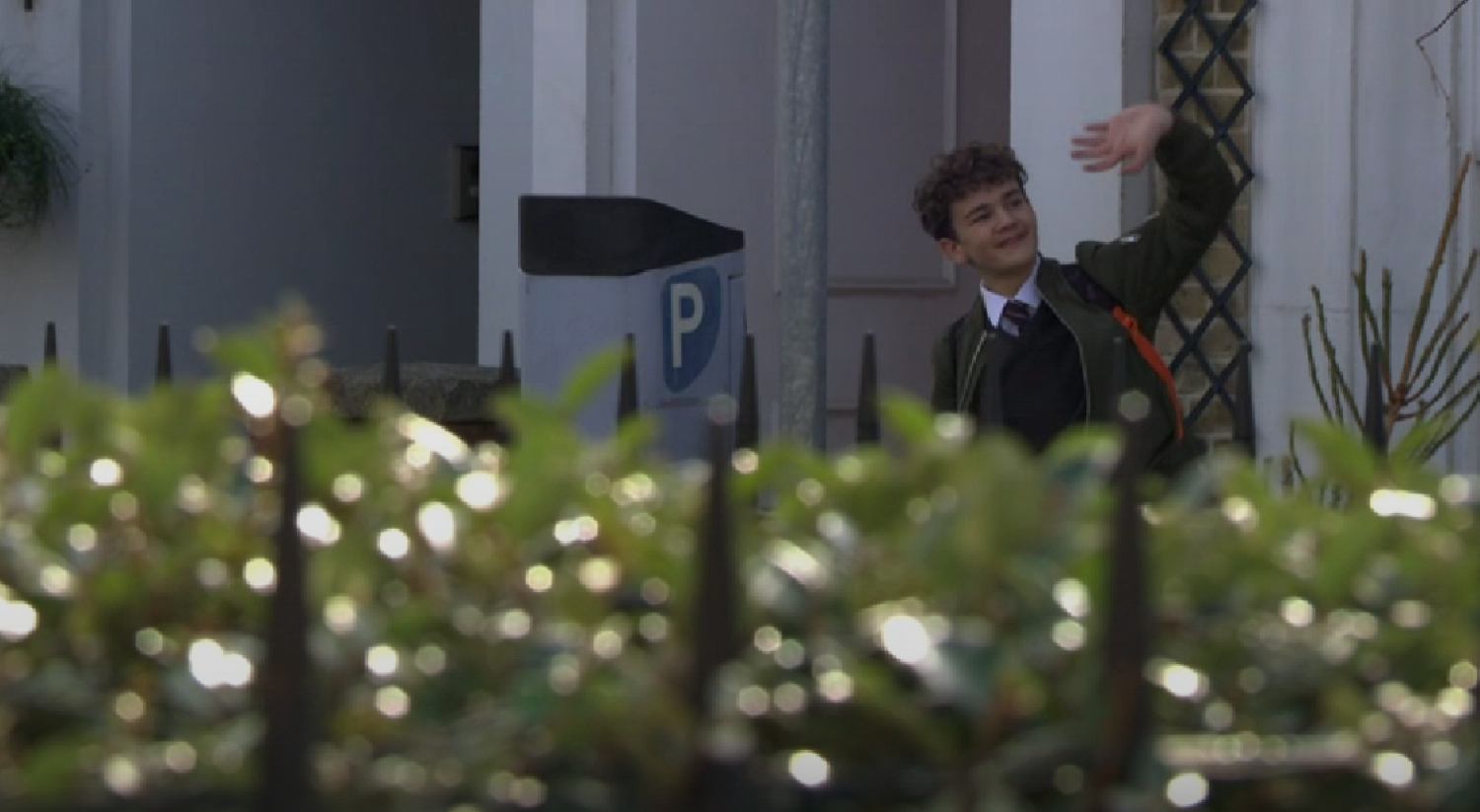 Ricky Mitchell smiling and waving in Albert Square