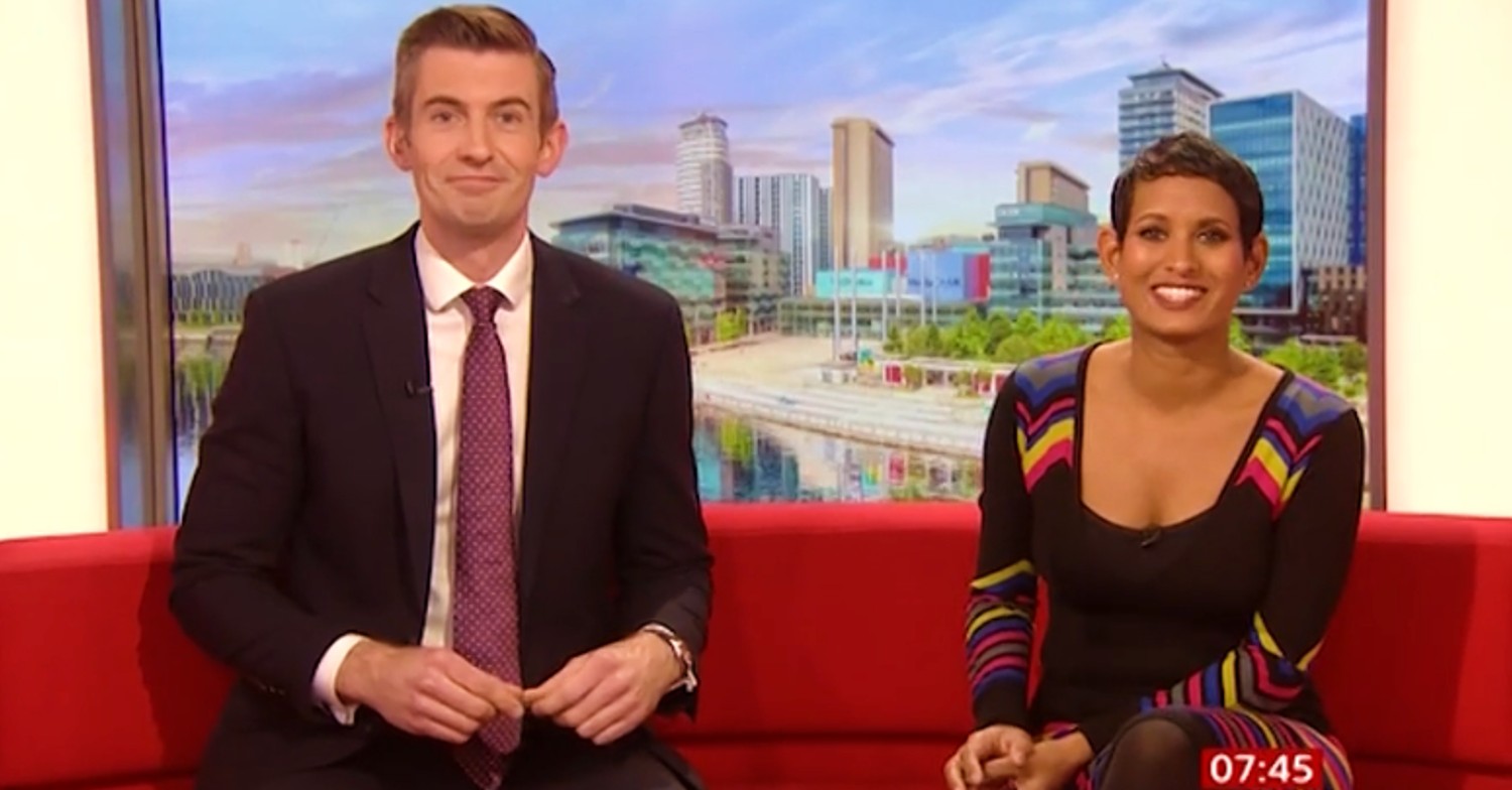 Ben Thompson and Naga Munchetty, in pattern dress, smiling on BBC Breakfast today
