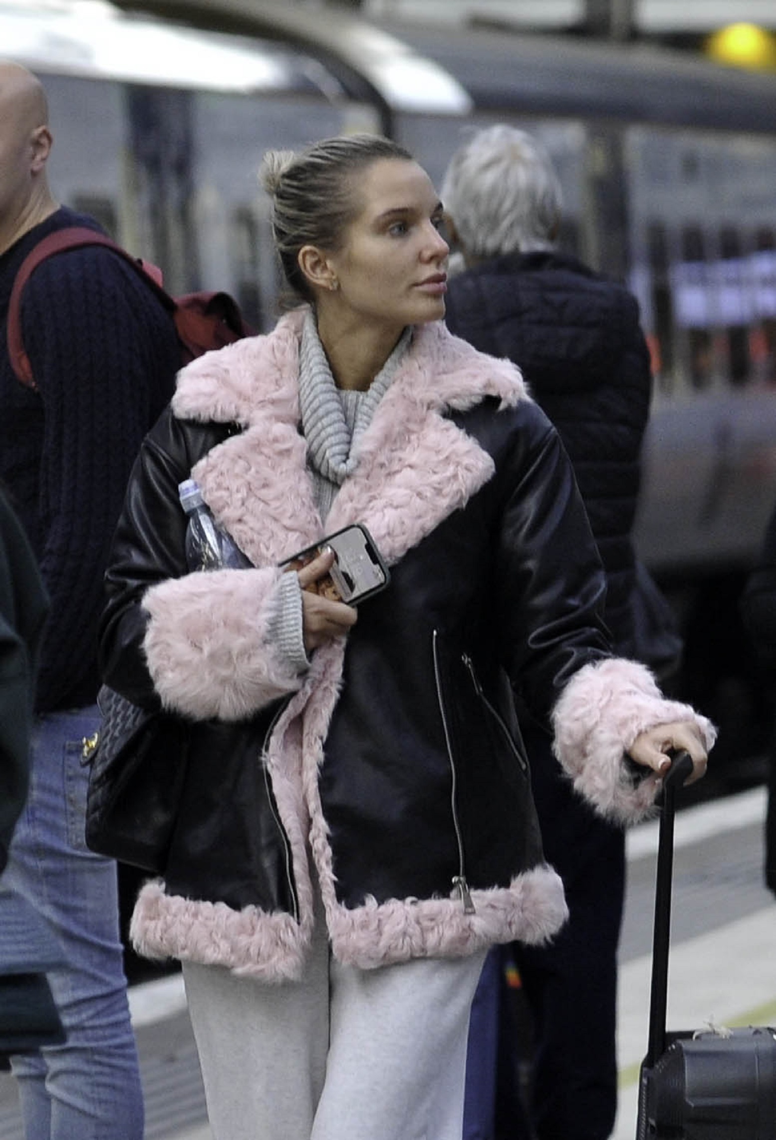 Helen Flanagan wearing a coat at the train station