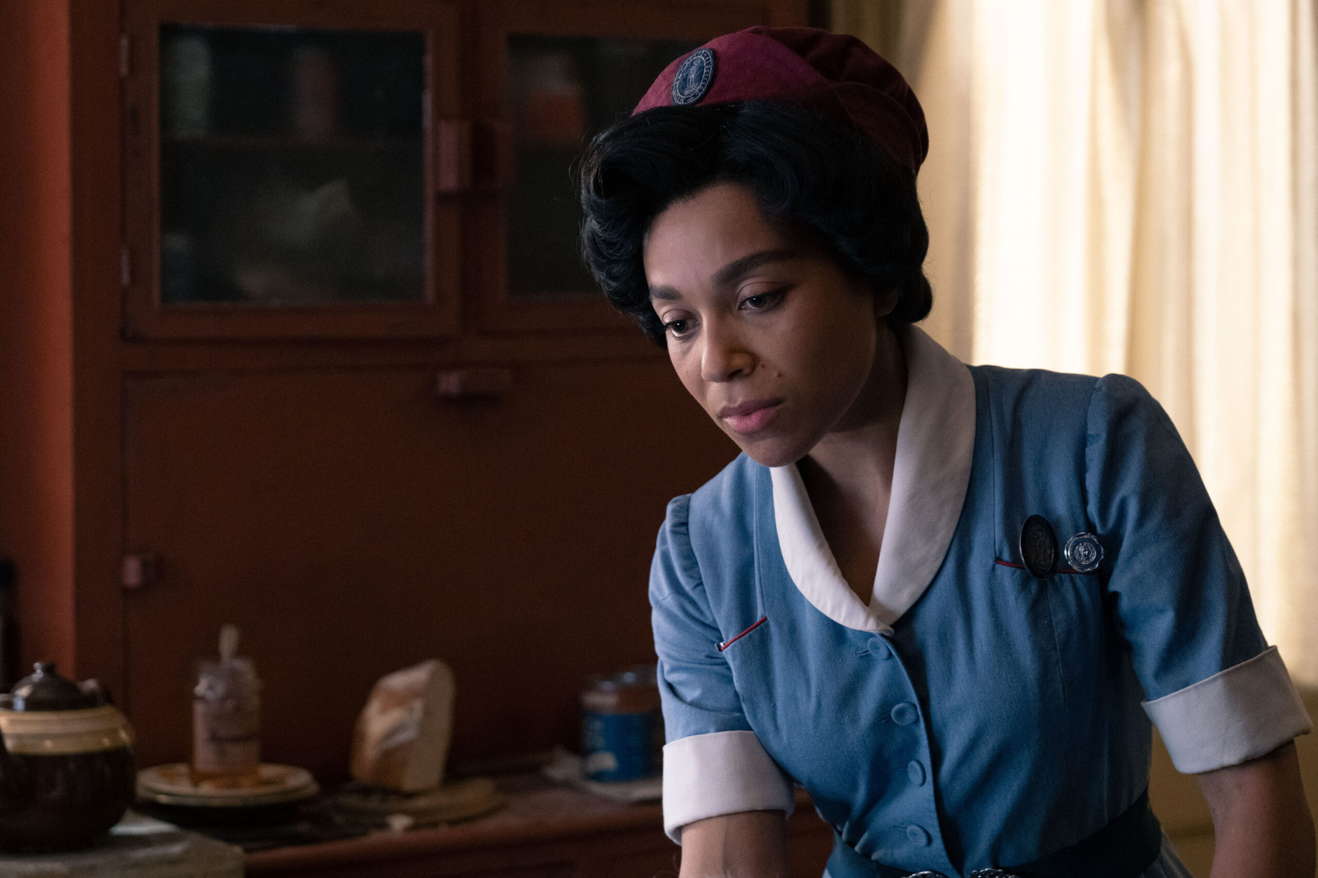 Lucille frowns in the Poplar in Call the Midwife