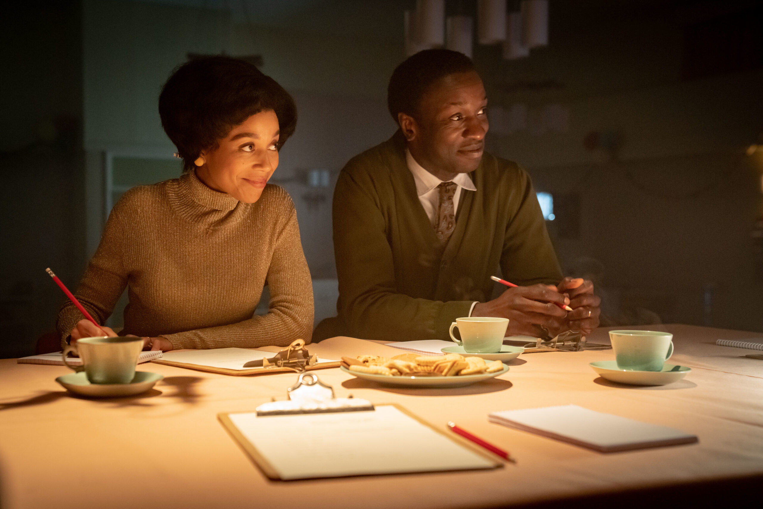 Lucille and Cyril sit at a table together in Call the Midwife