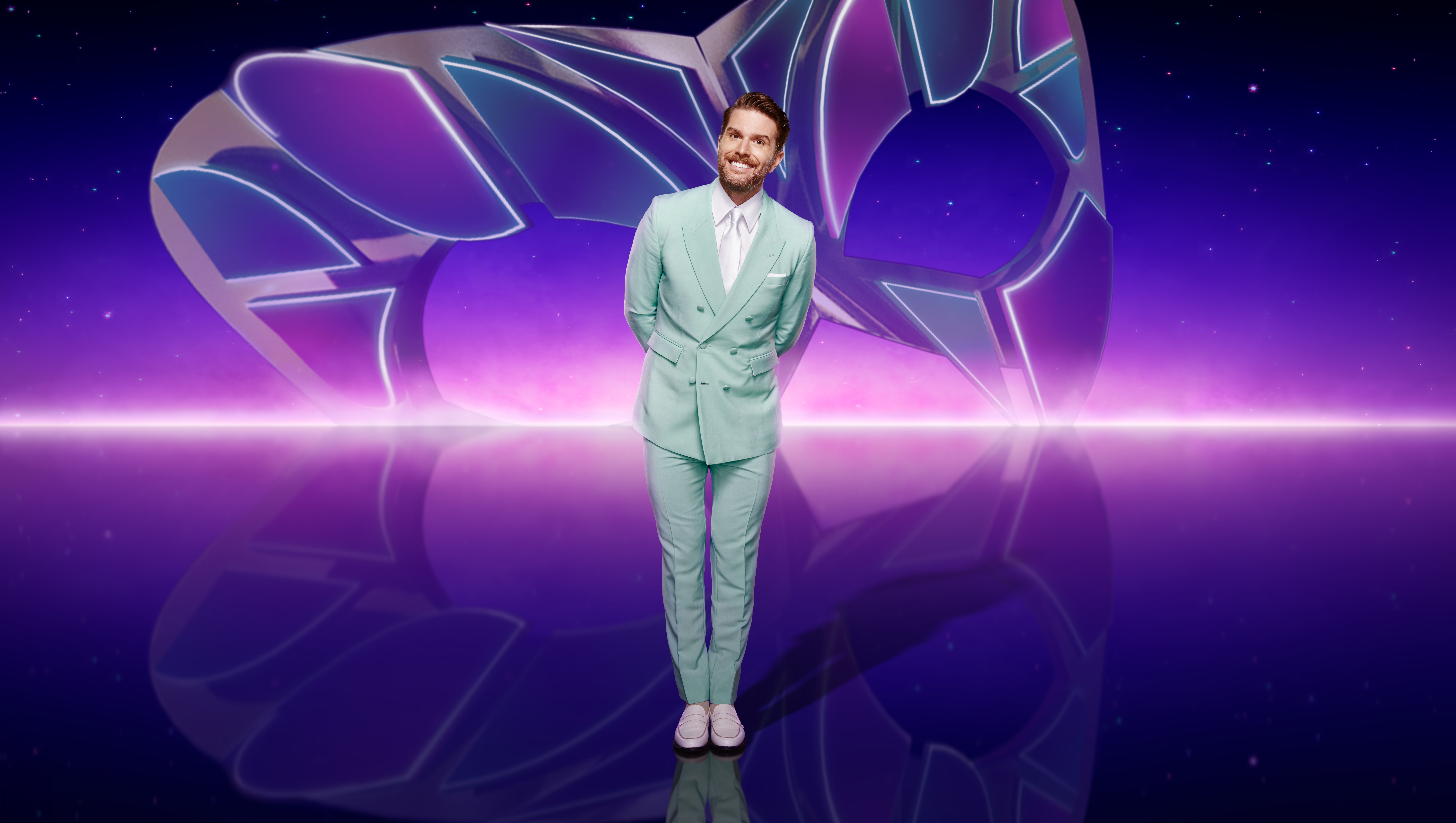 Joel Dommet in pastel mint suit promoting The Masked Singer