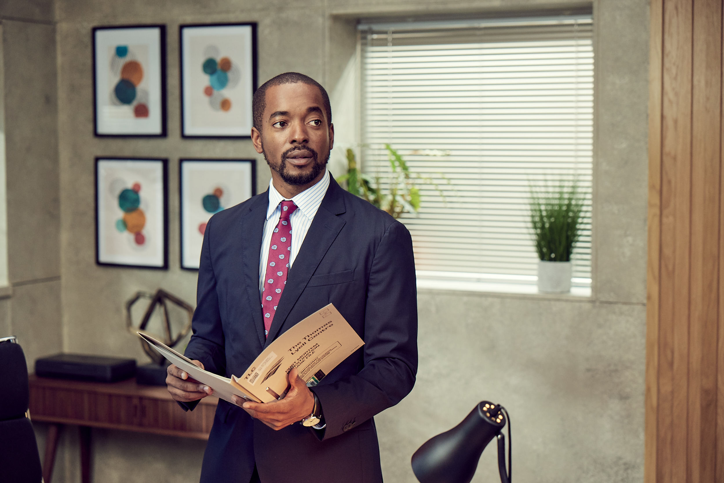 Dr Gabriel Folukoya looks up at Nikki in Silent Witness