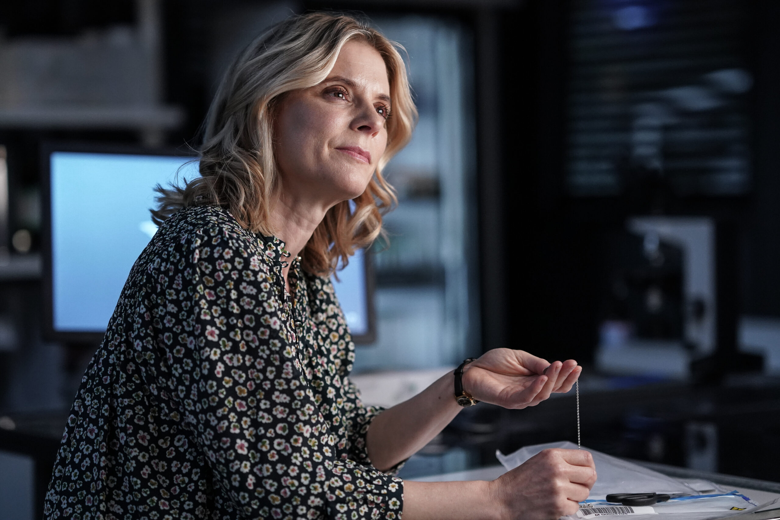 Nikki holds up a necklace in Silent Witness