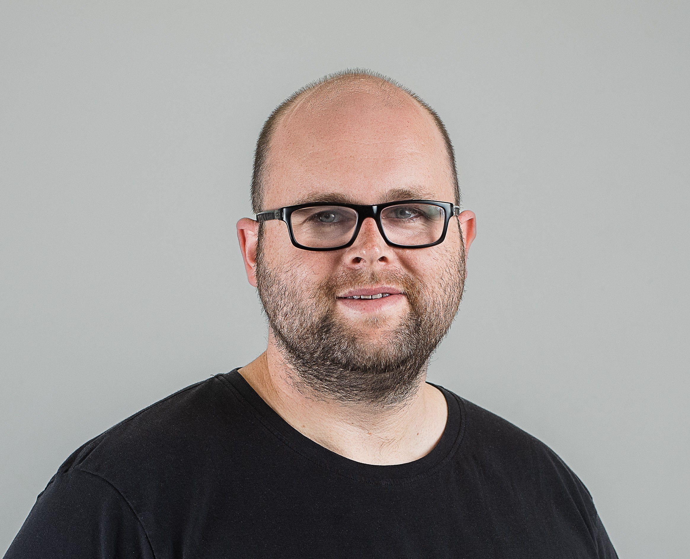 Man wearing glasses smiling to camera