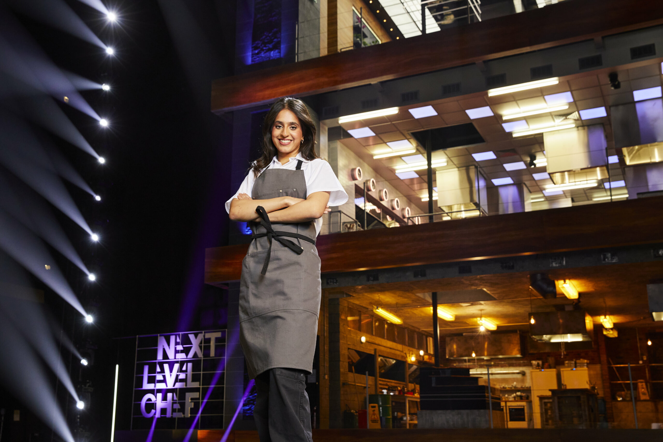 Gurpreet Bains folds her arms in the kitchen on Next Level Chef