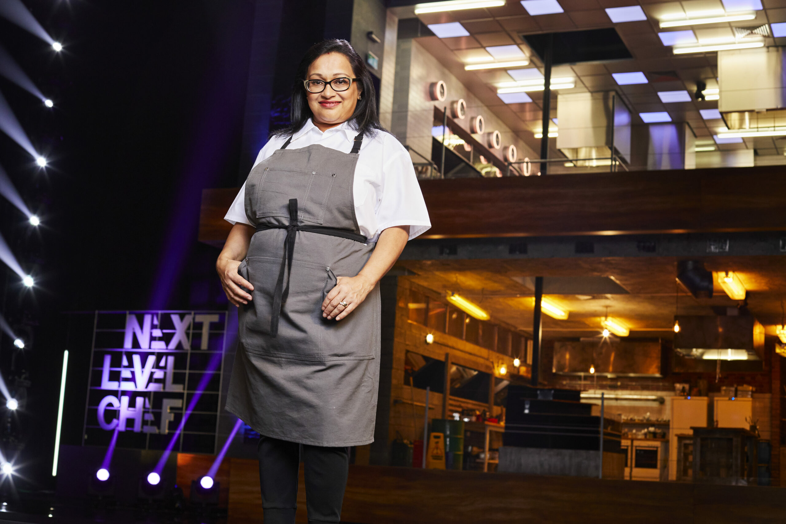 Next Level Chef contestant Tia Khurana smiles in the kitchen