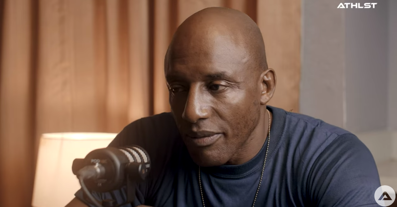 John speaks into a mic