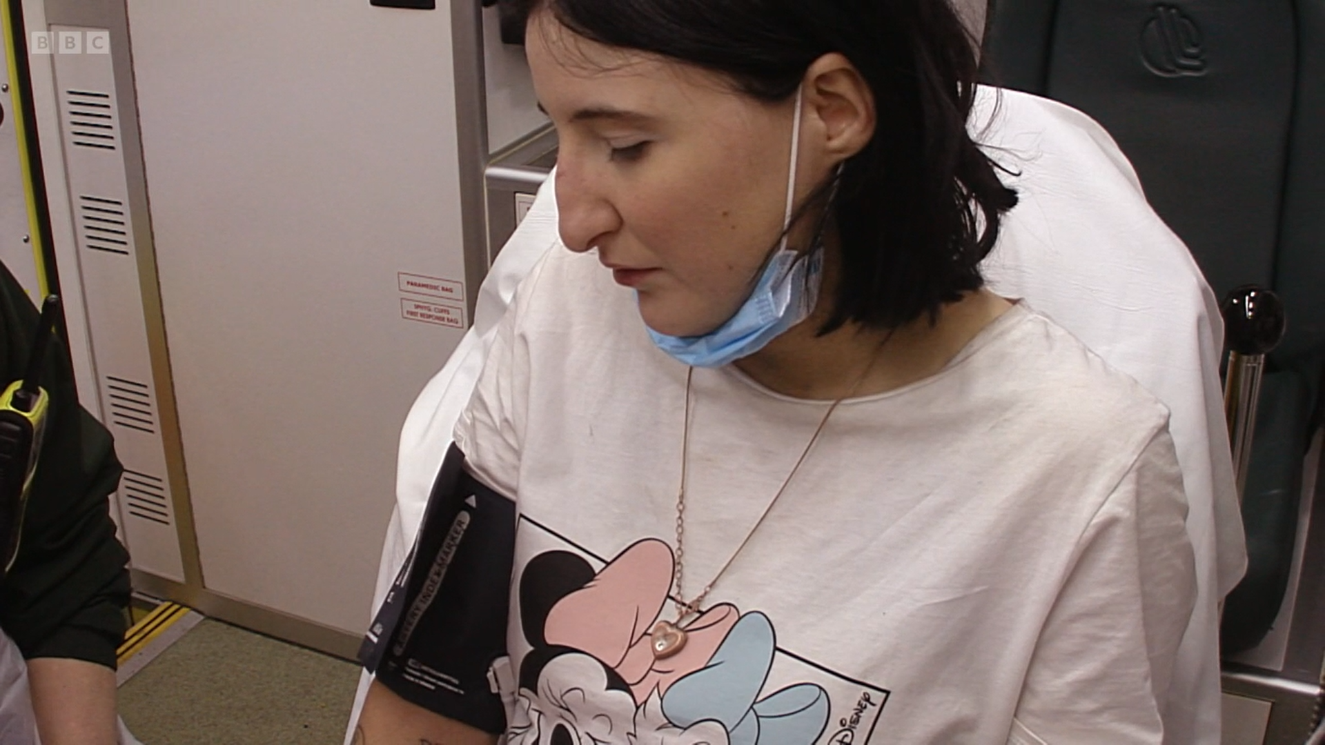 Kelly sits in the Ambulance with paramedics