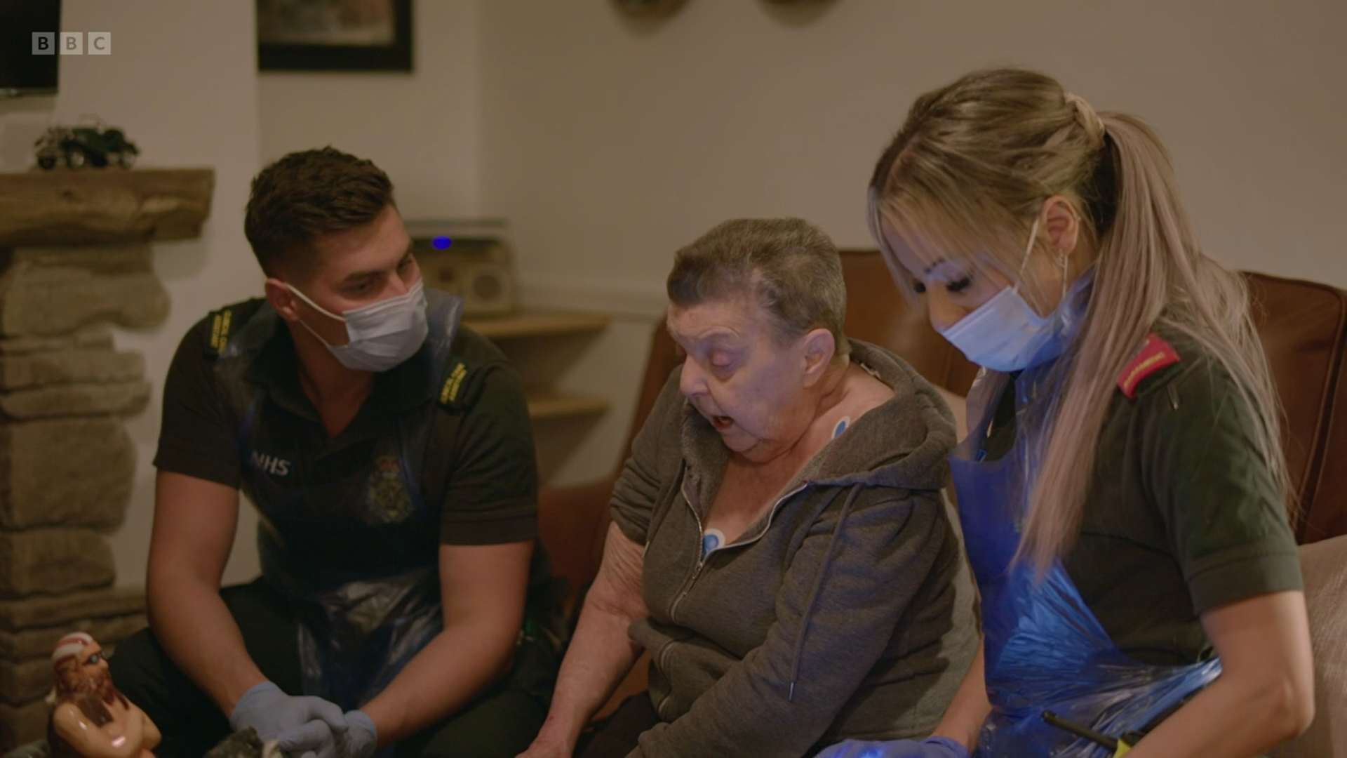 Doreen sits with paramedics Chris and Becca