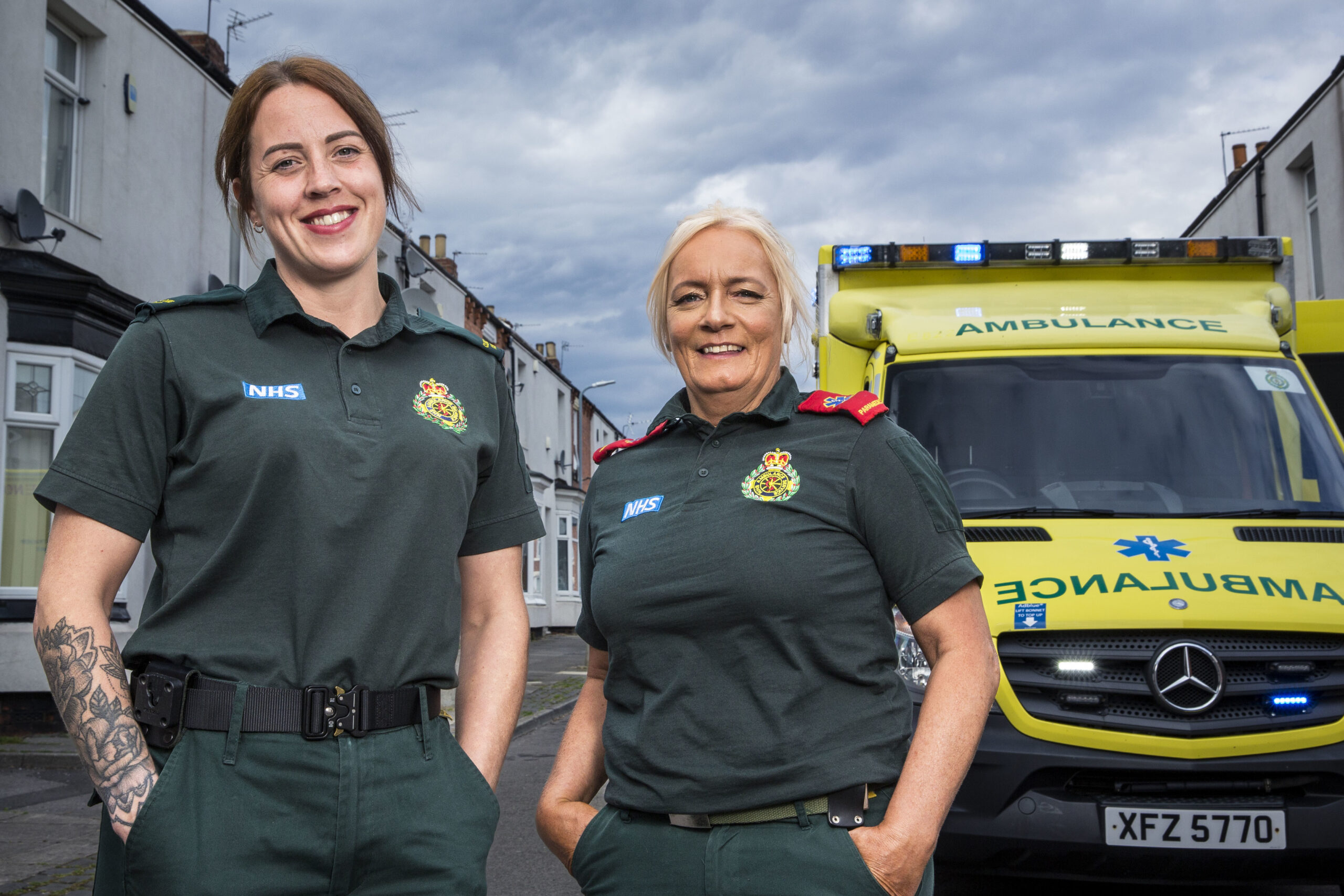 Caylie and Vanessa smile next to their Ambulance
