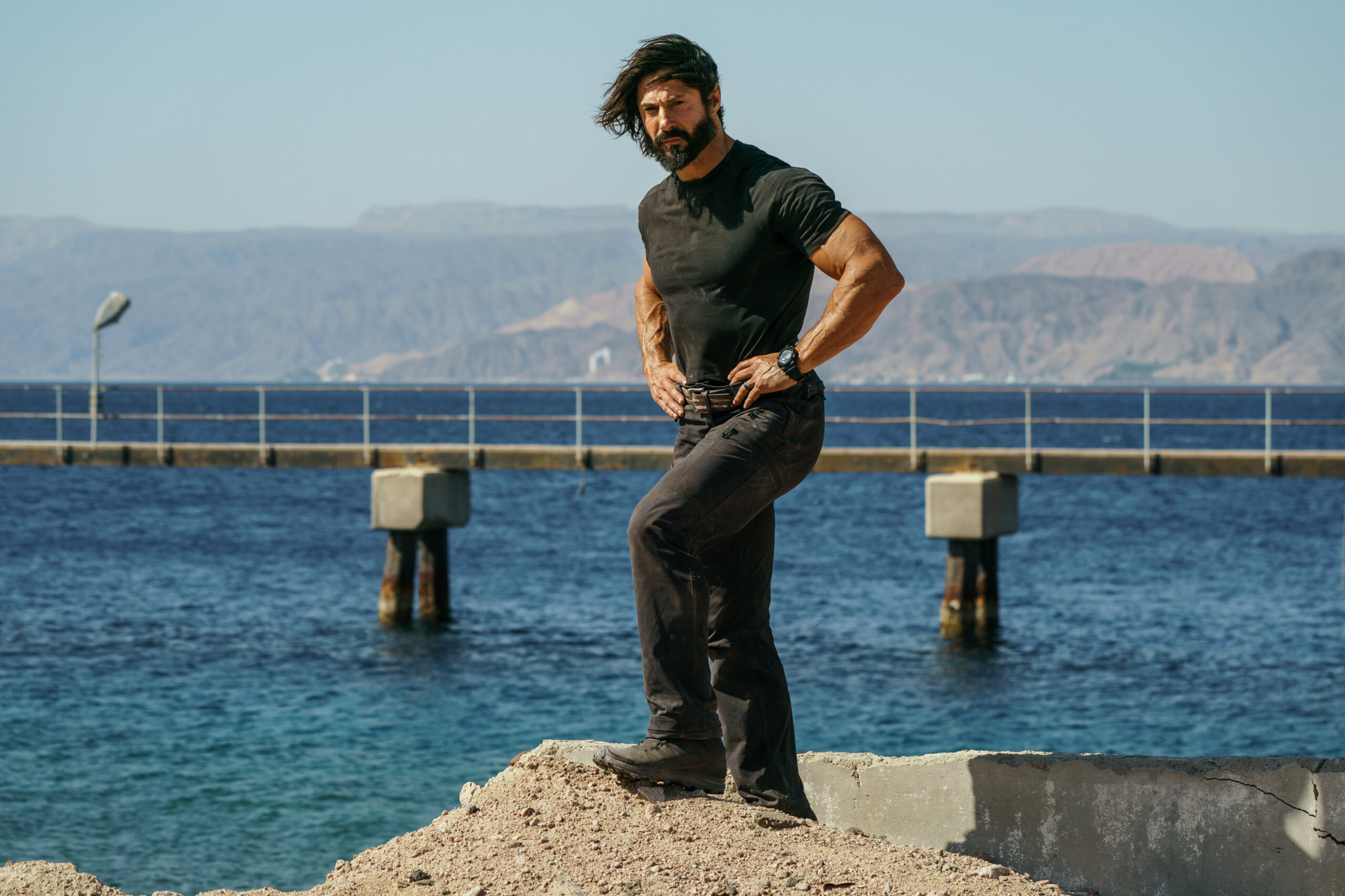Rudy Reyes stands on a rock in Celebrity SAS: Who Dares Wins