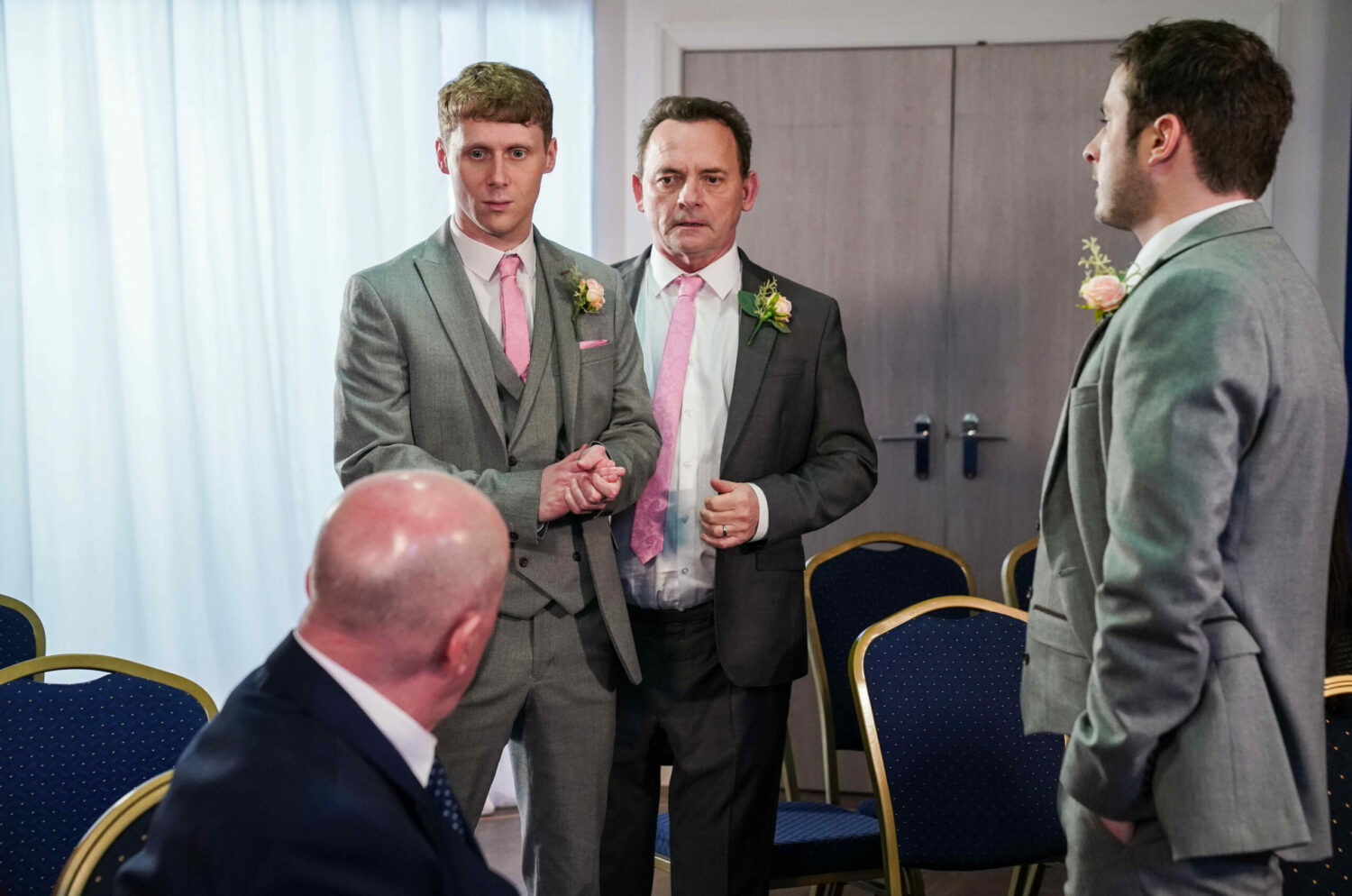 Jay and Billy in EastEnders look worried at the wedding