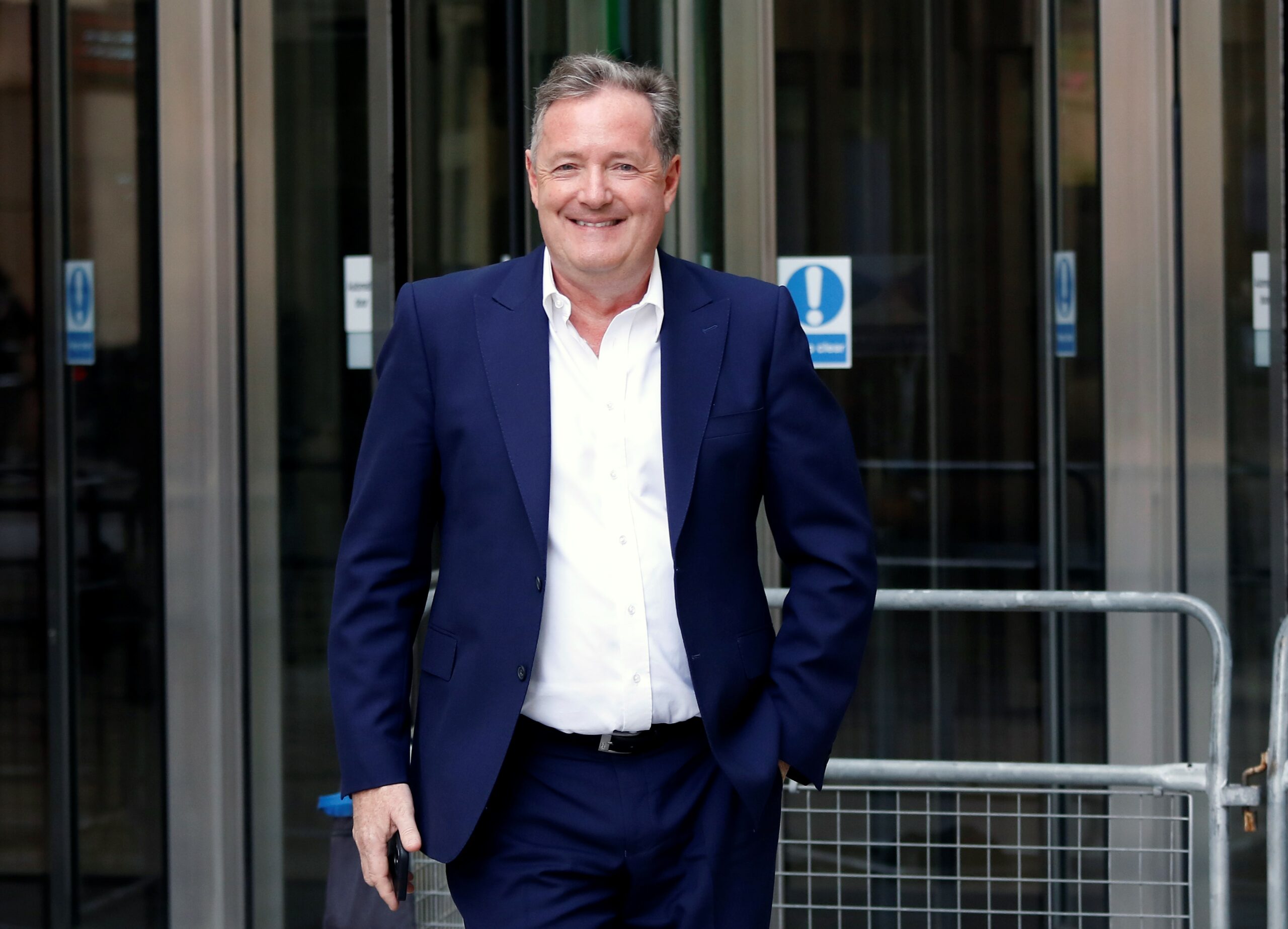 Piers Morgan smiles outside BBC studios