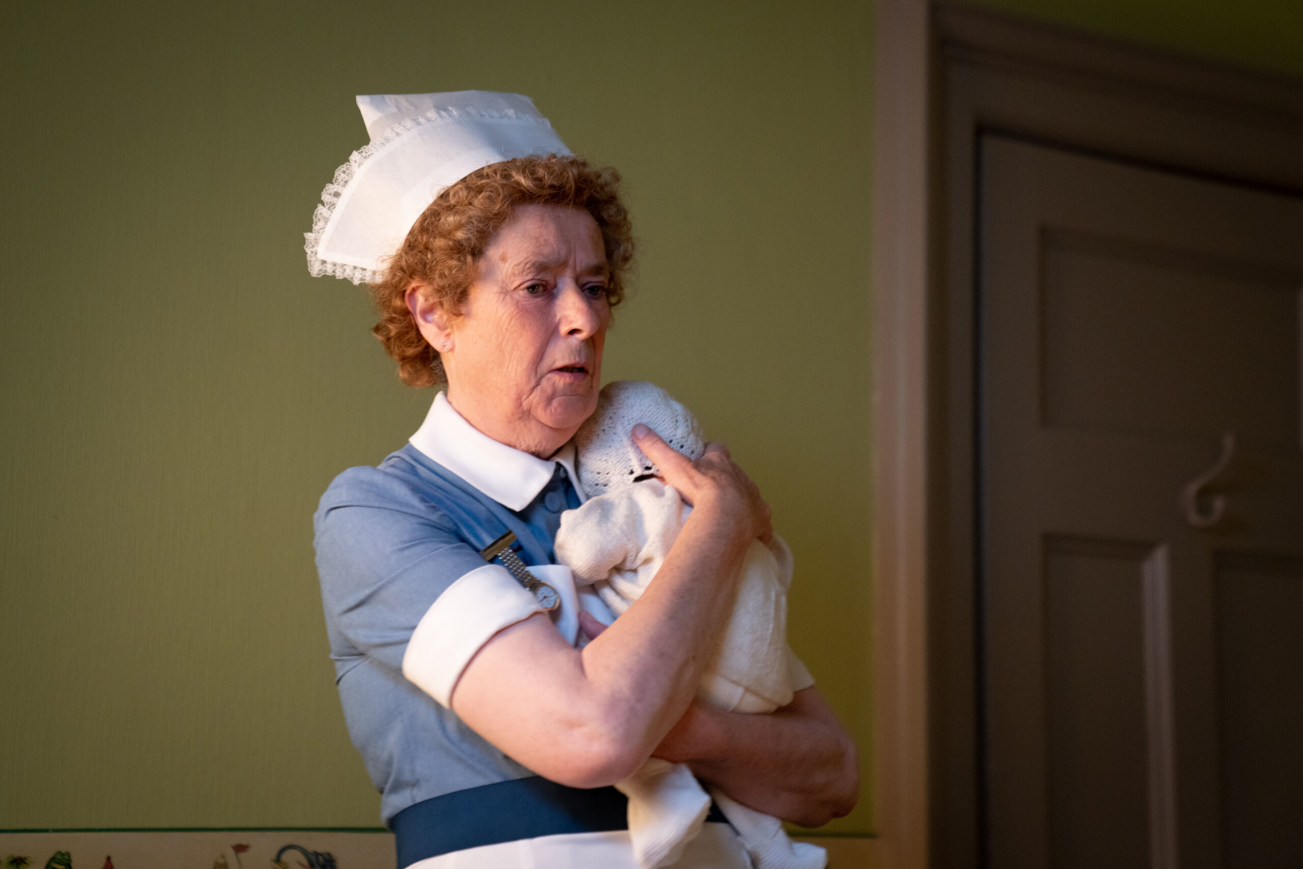 Nurse Crane cradles a baby in Call the Midwife