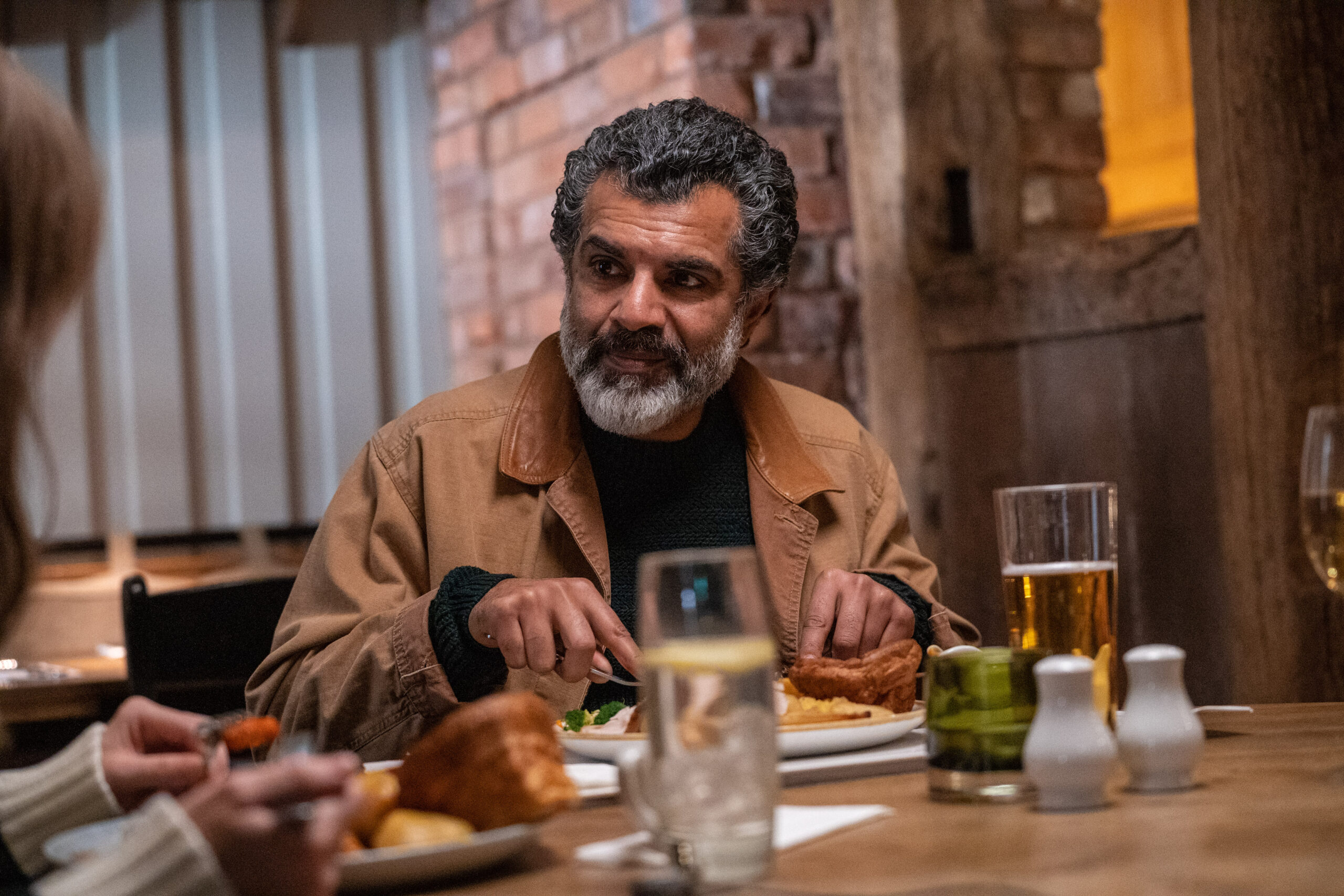 Ezra Faroque eating dinner in Without Sin