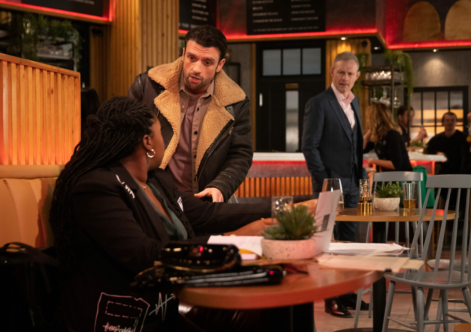 Damon flatters Dee-Dee in the bistro as Nick looks on worried in Coronation Street