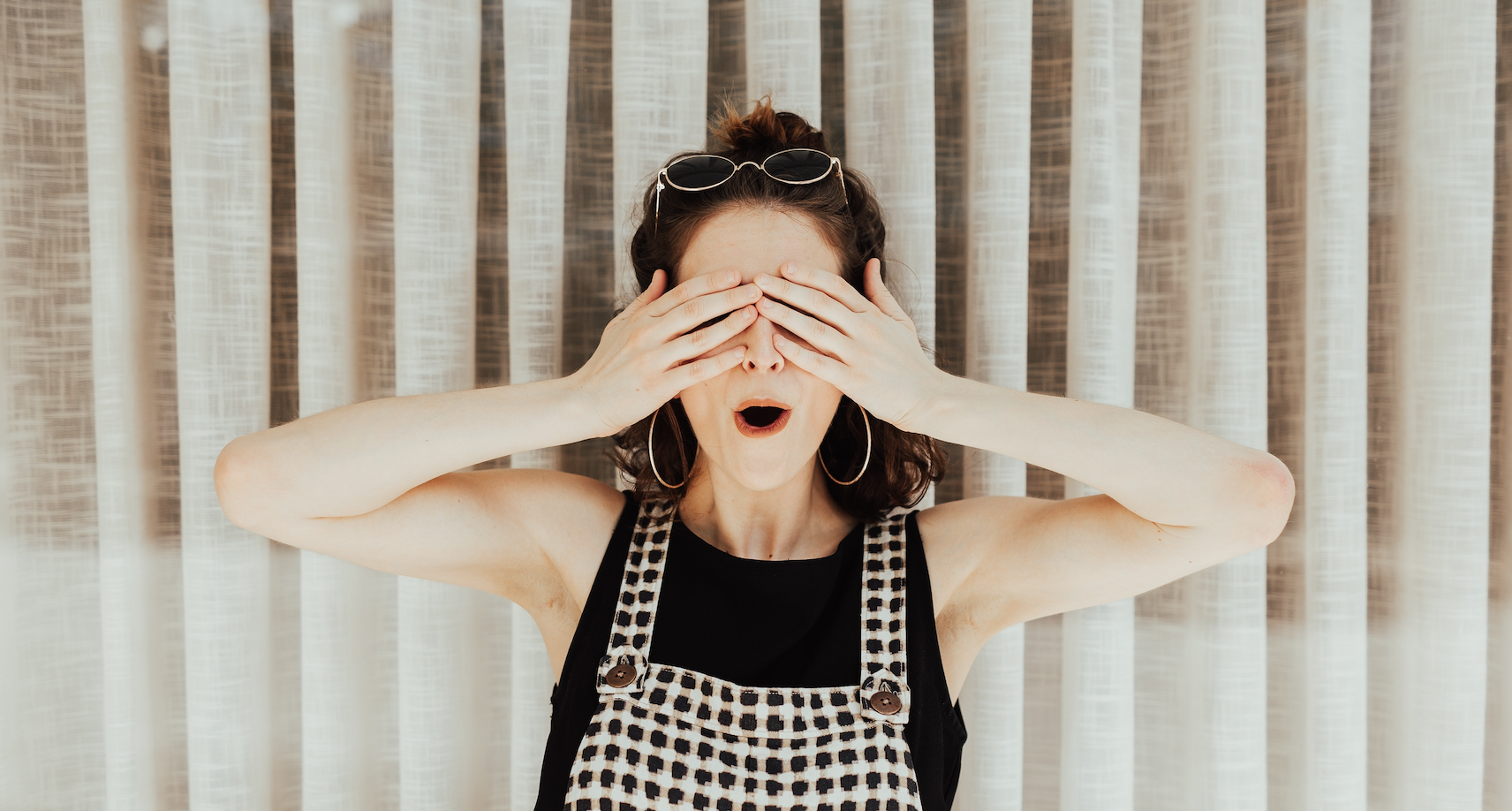 Woman hiding her eyes looking shocked