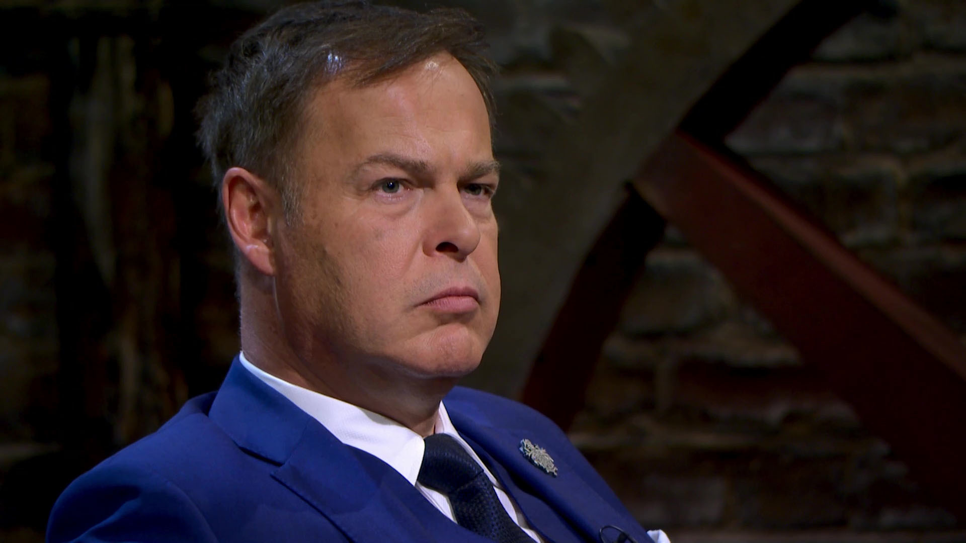 Peter Jones in blue suit on Dragons' Den
